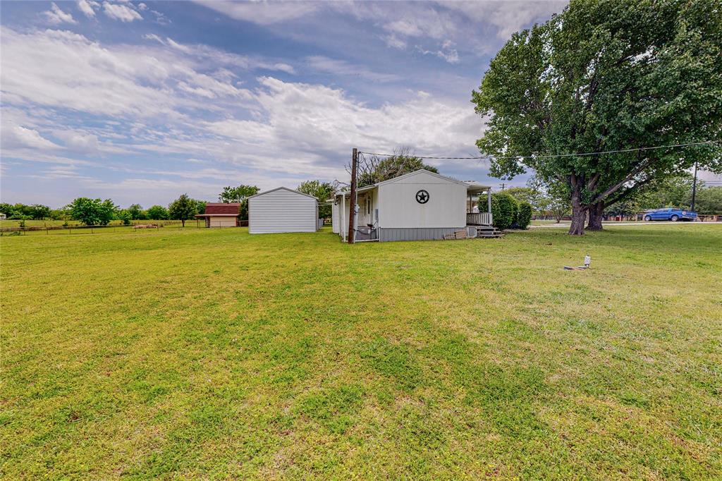 1501 Joyce Road Kaufman, TX 75142 - Photo 30 of 37 a front view of a house with a garden and trees