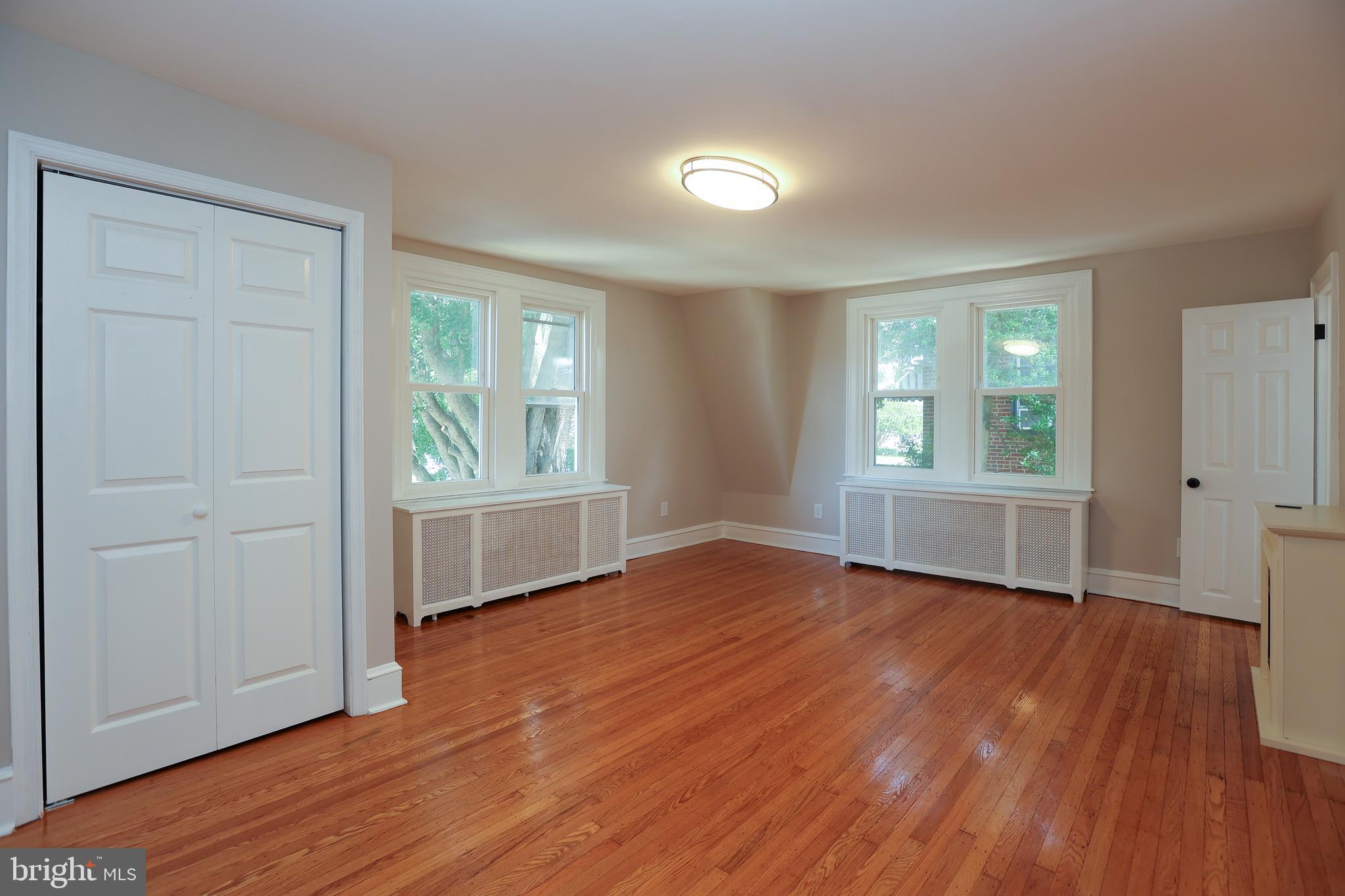 12 East Providence Road Lansdowne, PA 19050 - Photo 15 of 30 an empty room with wooden floor and windows