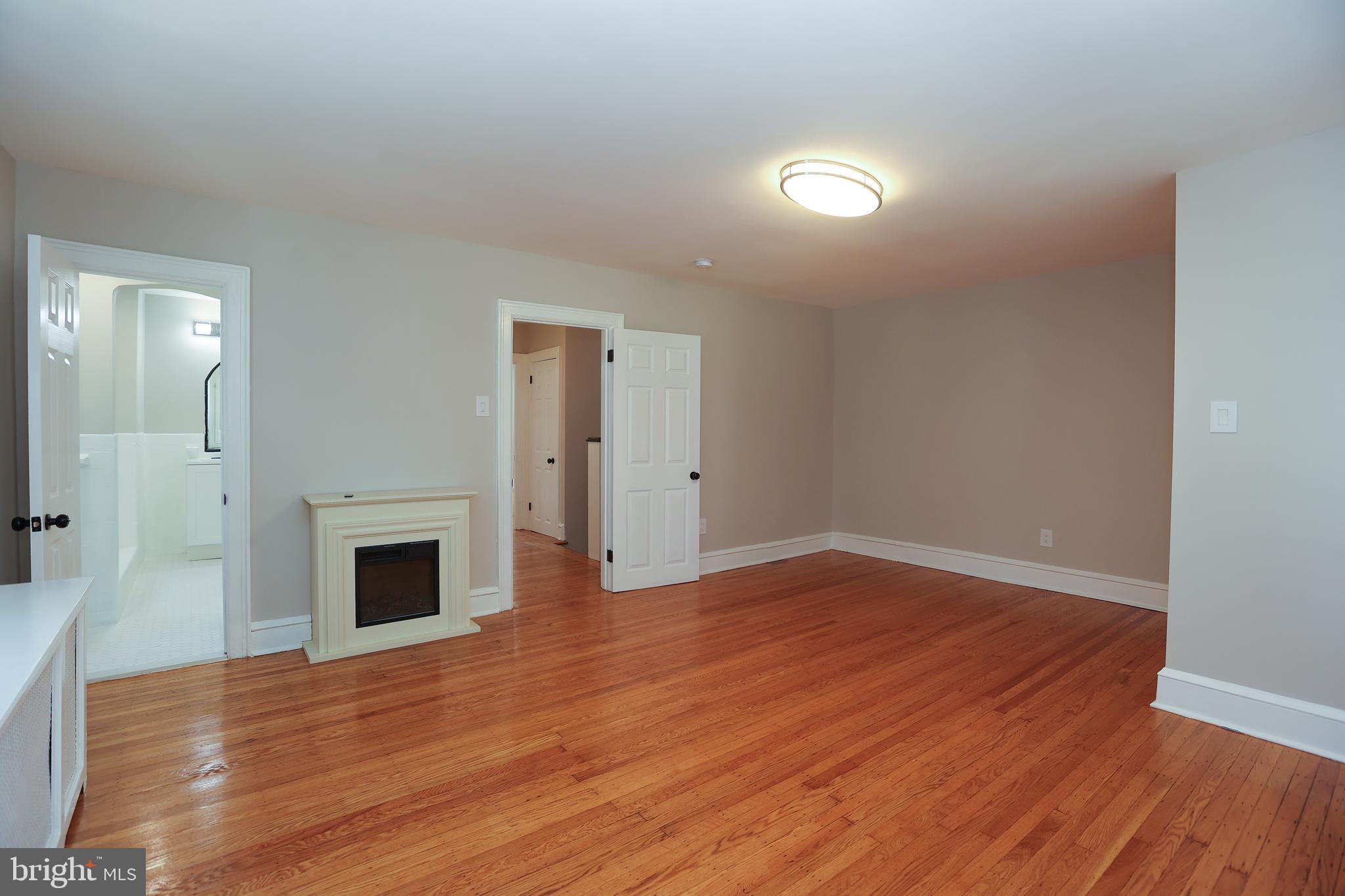 12 East Providence Road Lansdowne, PA 19050 - Photo 16 of 30 a view of empty room with wooden floor and fireplace
