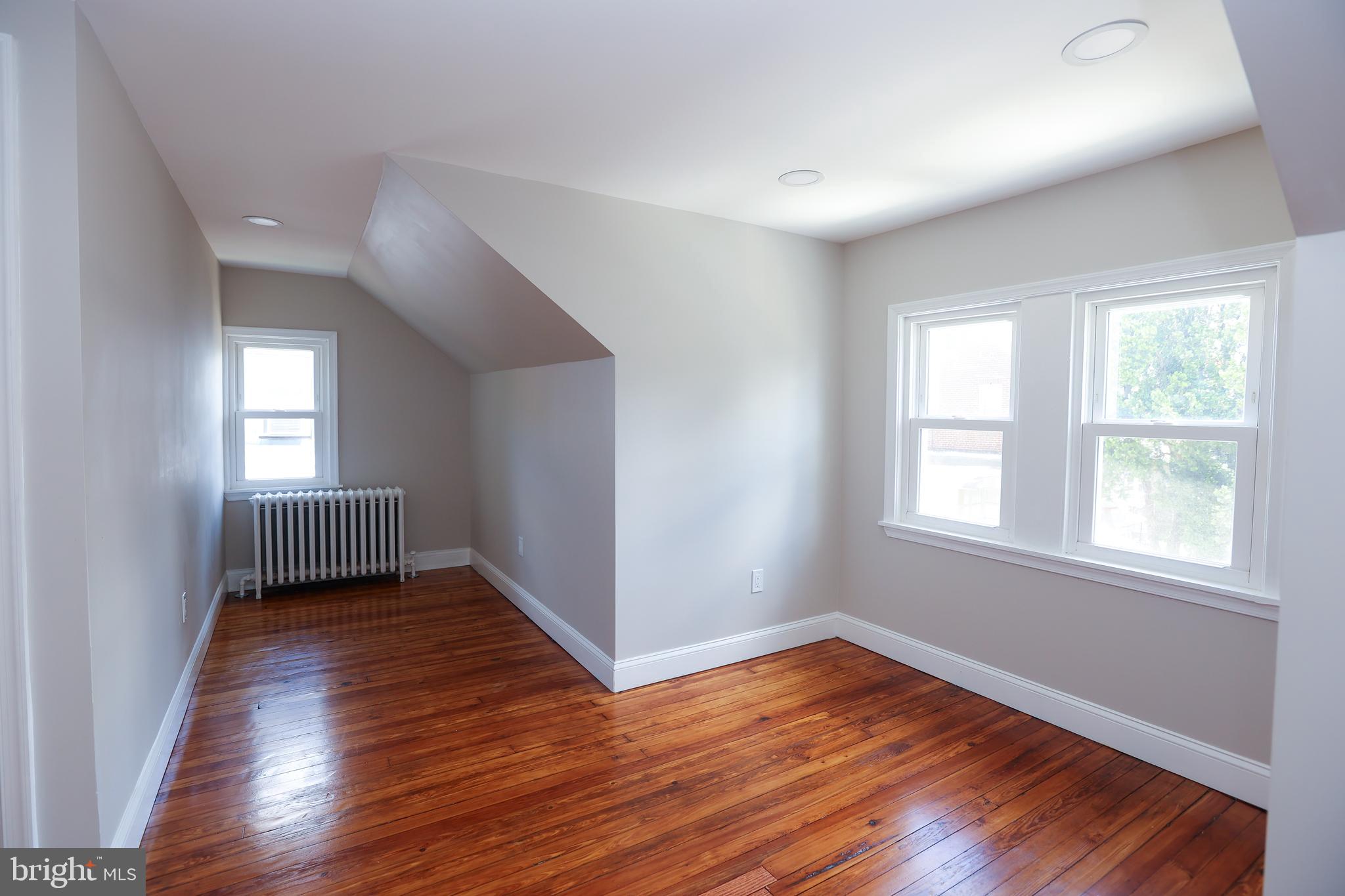 12 East Providence Road Lansdowne, PA 19050 - Photo 20 of 30 an empty room with wooden floor and windows