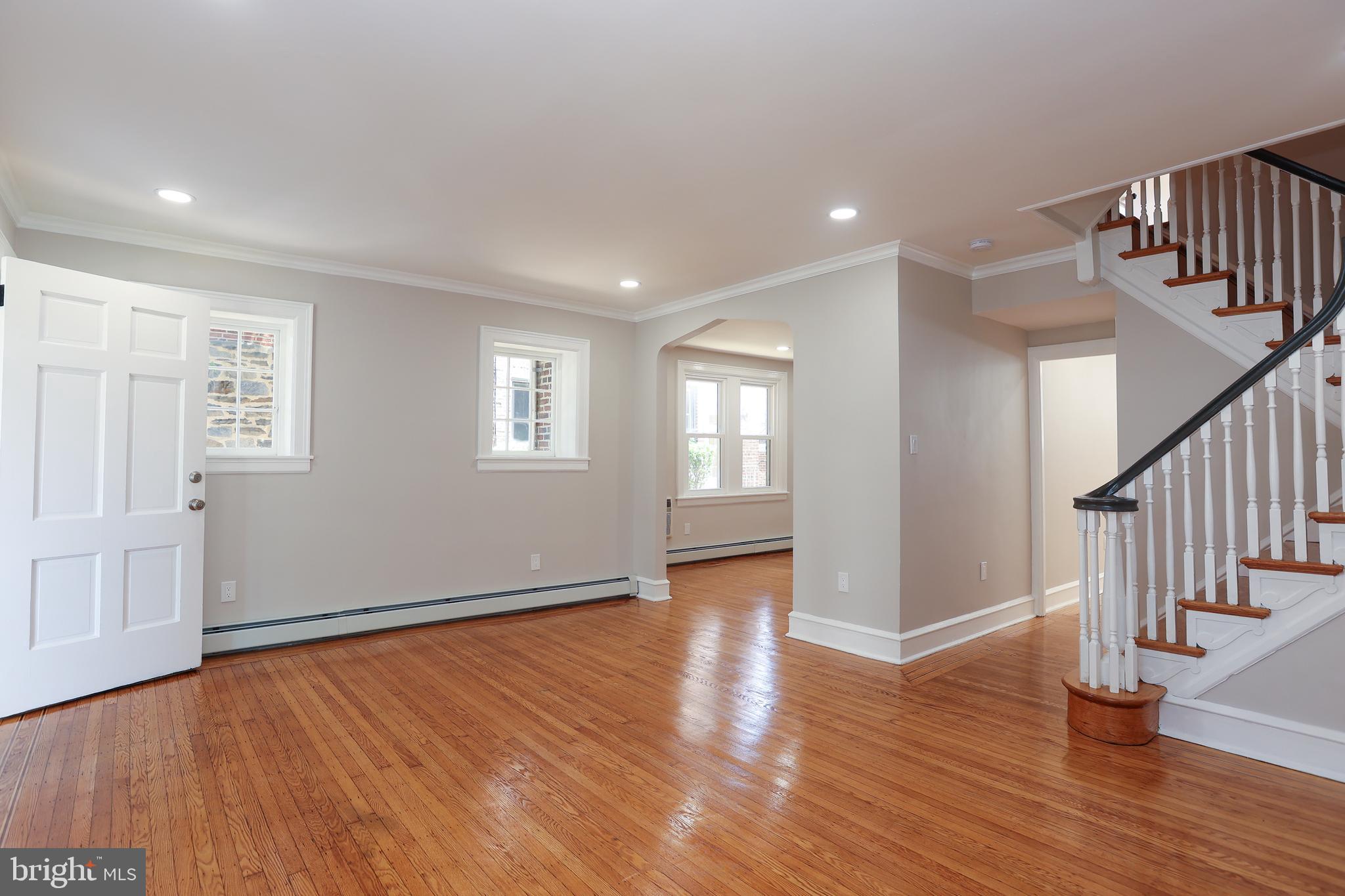 12 East Providence Road Lansdowne, PA 19050 - Photo 4 of 30 a view of an empty room with wooden floor and a window