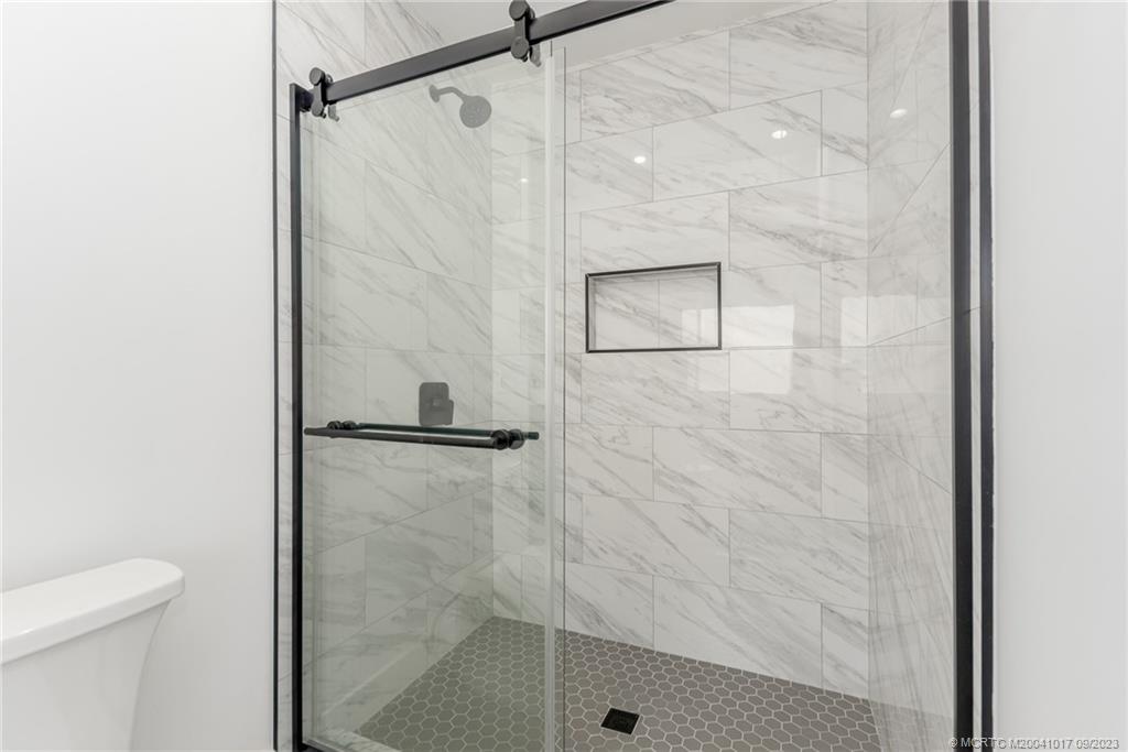 5008 Southeast Major Way Stuart, FL 34997 - Photo 14 of 20 a bathroom with a shower and a toilet