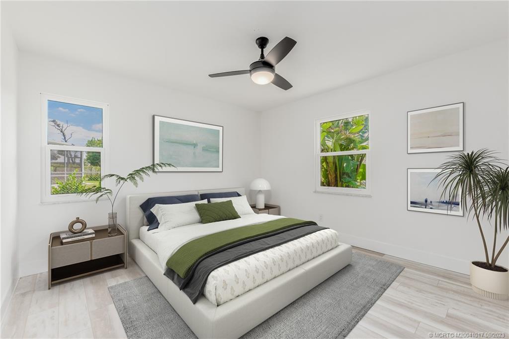 5008 Southeast Major Way Stuart, FL 34997 - Photo 15 of 20 a bedroom with bed and a window