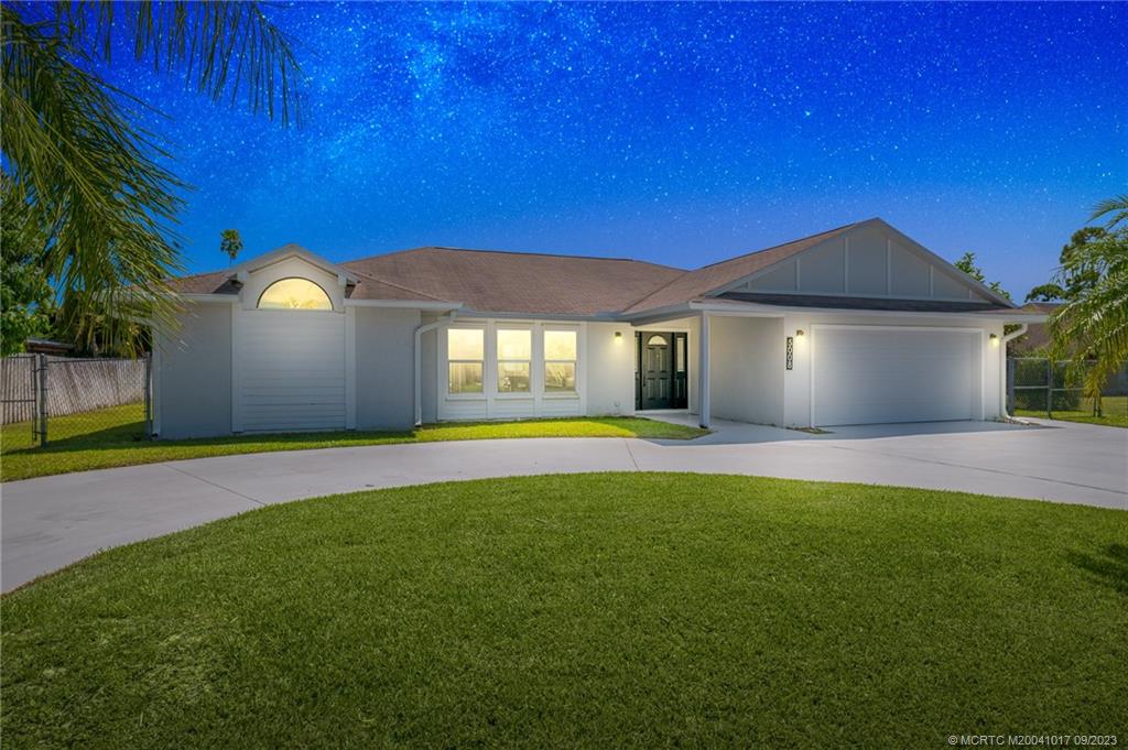 5008 Southeast Major Way Stuart, FL 34997 - Photo 2 of 20 a view of a house with a big yard