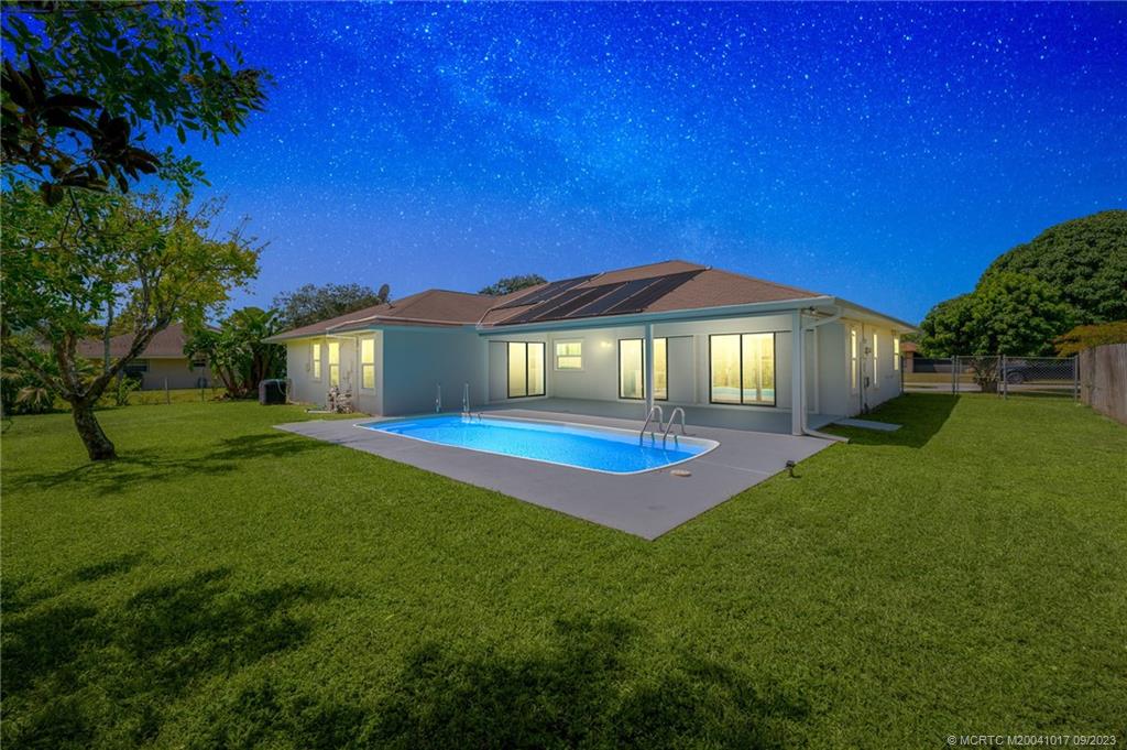 5008 Southeast Major Way Stuart, FL 34997 - Photo 3 of 20 a front view of a house with a yard