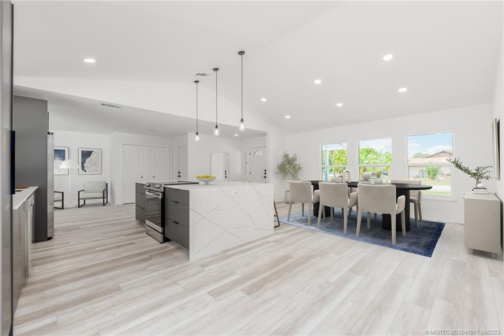 5008 Southeast Major Way Stuart, FL 34997 - Photo 6 of 20 a large kitchen with a table and chairs in it