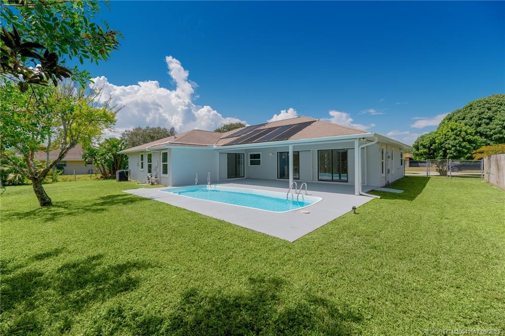 5008 Southeast Major Way Stuart, FL 34997 - Photo 8 of 20 a front view of a house with a yard
