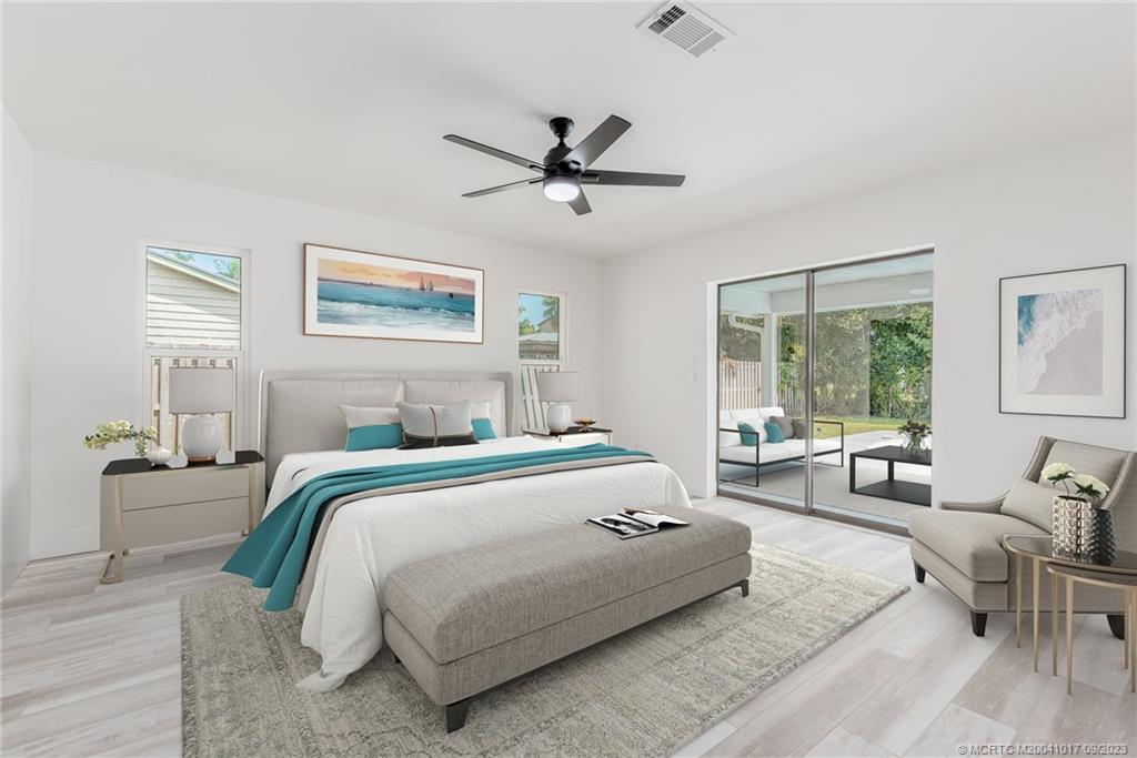 5008 Southeast Major Way Stuart, FL 34997 - Photo 9 of 20 a bedroom with a large bed and a couch