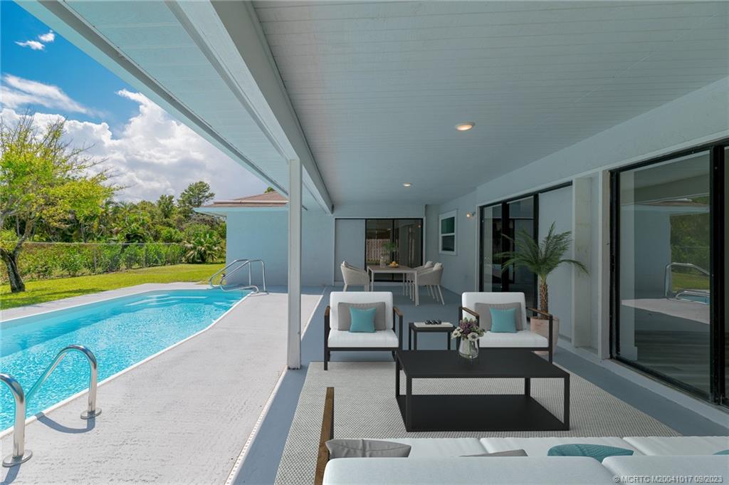 5008 Southeast Major Way Stuart, FL 34997 - Photo 10 of 20 a living room with patio furniture and garden