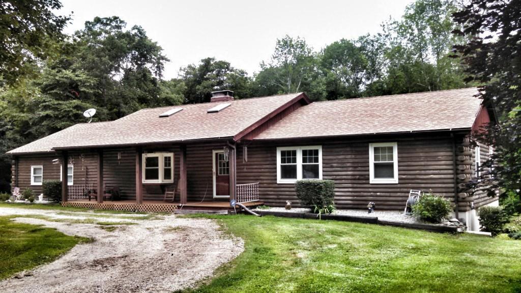 Fantastic log home, on private road in Hebron. U-shaped driveway, nice landscaping
