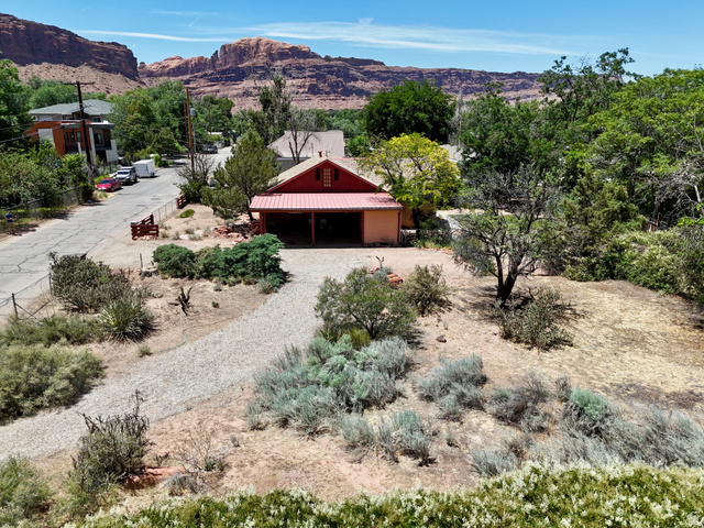 178 Walnut Lane Moab, UT 84532 - Photo 4 of 25 Red-sided structure featuring a covered porch with a metal roof