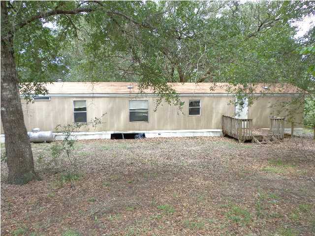 6120 Old River Road Baker, FL 32531 - Photo 2 of 7 front view of a house with a chairs and table