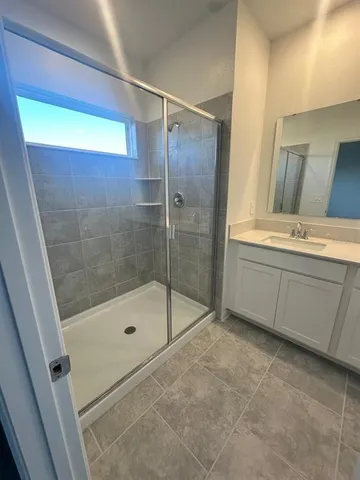 a bathroom with a shower and a sink