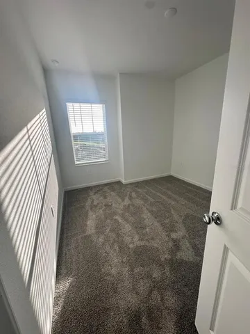 a view of room with window and hardwood floor