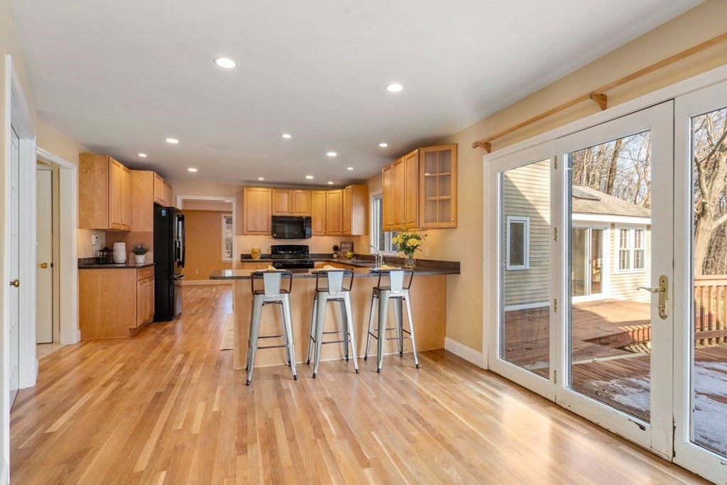 9 R Conant Street Acton, MA 01720 - Photo 12 of 42 a view of kitchen with kitchen island wooden floor center island and stainless steel appliances
