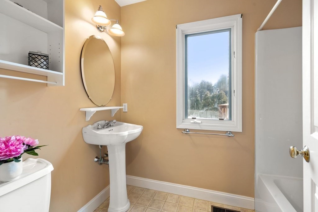 9 R Conant Street Acton, MA 01720 - Photo 20 of 42 a bathroom with a sink a mirror and a toilet