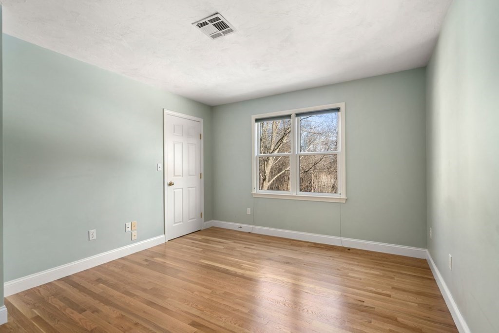 9 R Conant Street Acton, MA 01720 - Photo 22 of 42 an empty room with wooden floor and windows