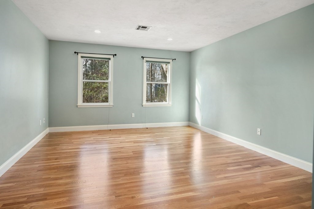 9 R Conant Street Acton, MA 01720 - Photo 23 of 42 a view of an empty room with wooden floor and a window
