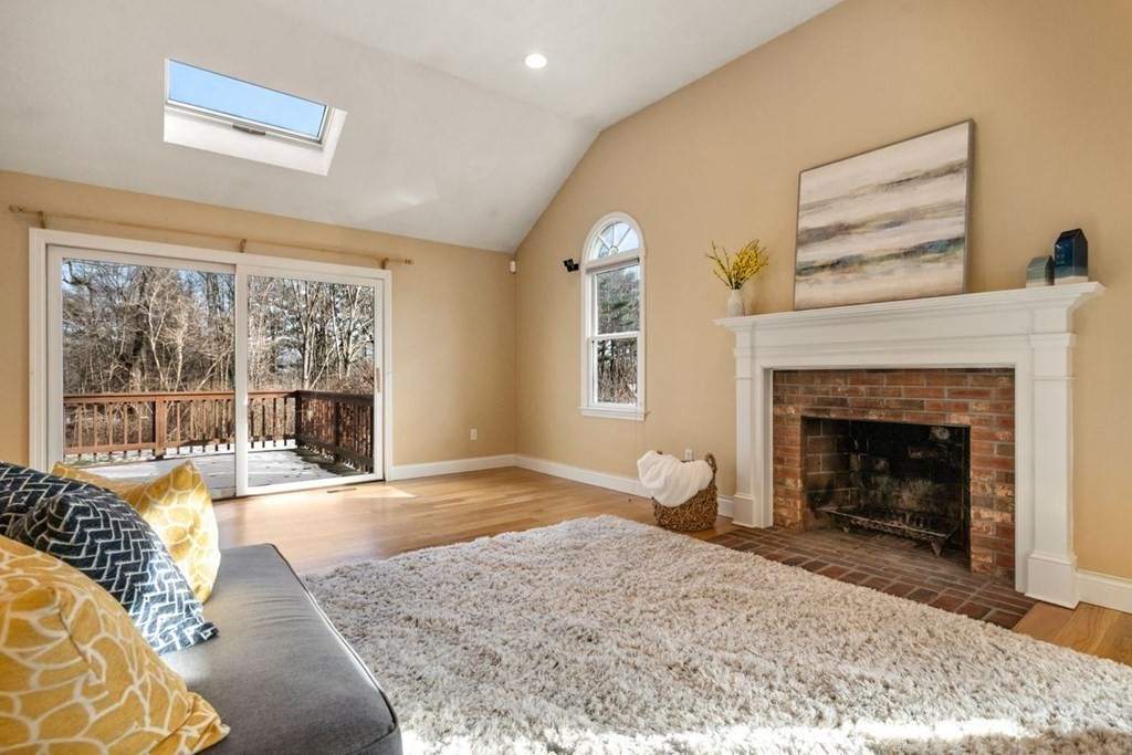 9 R Conant Street Acton, MA 01720 - Photo 5 of 42 a view of a livingroom with a fireplace and large windows