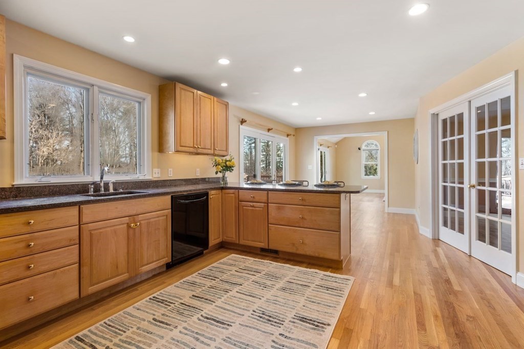9 R Conant Street Acton, MA 01720 - Photo 8 of 42 a open kitchen with kitchen island granite countertop wooden floors granite counter tops and a window