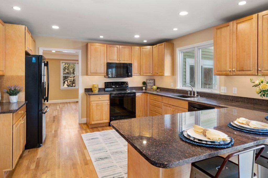 9 R Conant Street Acton, MA 01720 - Photo 9 of 42 a kitchen with stainless steel appliances granite countertop a sink a stove and a refrigerator