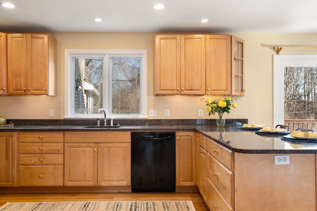 9 R Conant Street Acton, MA 01720 - Photo 10 of 42 a kitchen with granite countertop a sink a stove and cabinets