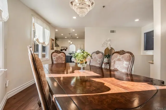 a dining room with furniture and wooden floor