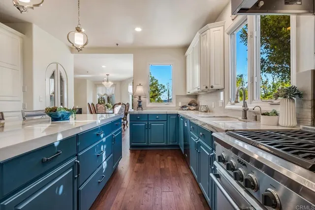 a kitchen with stainless steel appliances a sink stove and cabinets