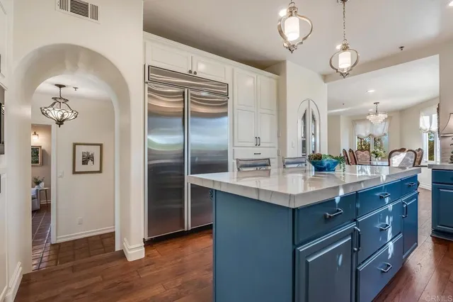 a kitchen with stainless steel appliances granite countertop a sink and a refrigerator