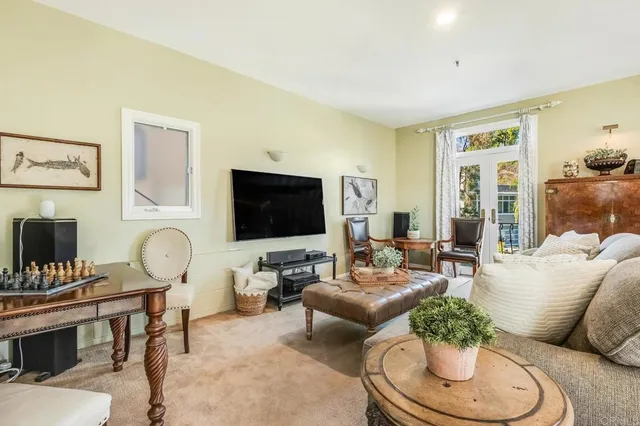 a living room with furniture a flat screen tv and a fireplace