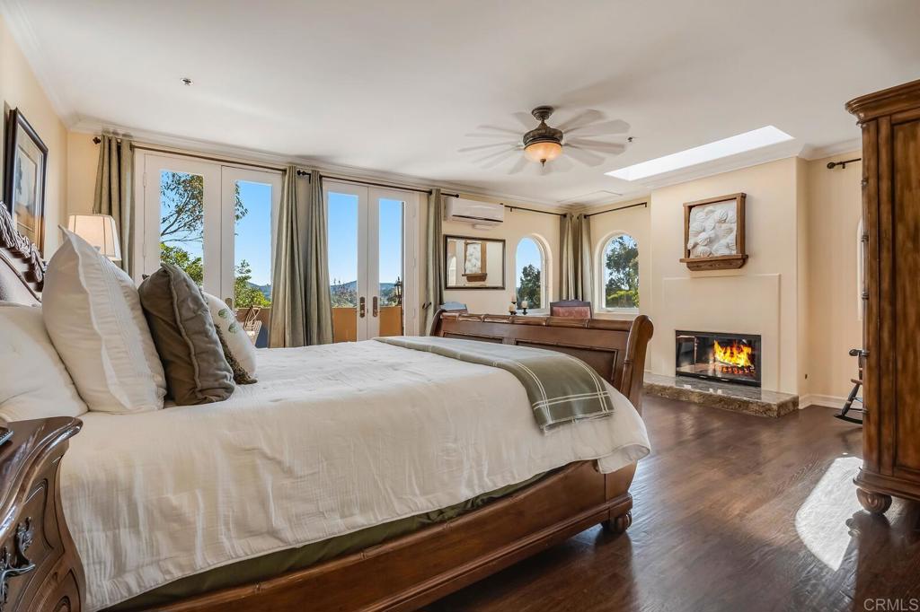 136 Hummingbird Hill Encinitas, CA 92024 - Photo 27 of 54 a bedroom with a bed and a fireplace