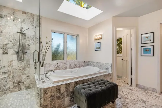 a view of a bedroom with furniture and a window