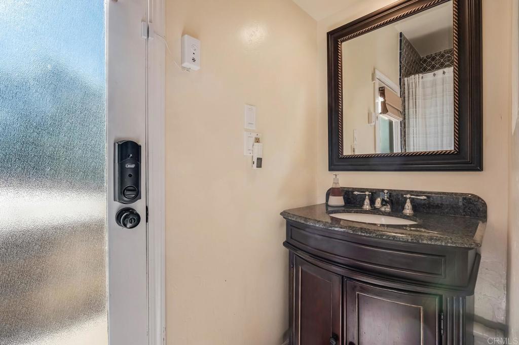 136 Hummingbird Hill Encinitas, CA 92024 - Photo 37 of 54 a bathroom with a sink and a mirror