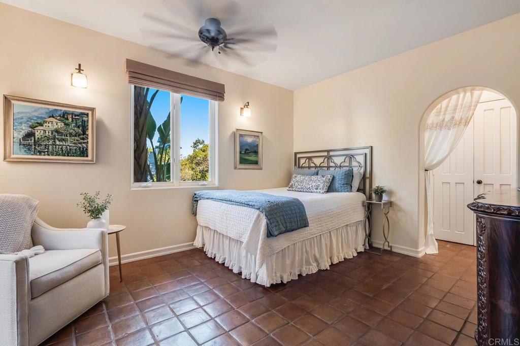 136 Hummingbird Hill Encinitas, CA 92024 - Photo 38 of 54 a bedroom with a bed and a chandelier