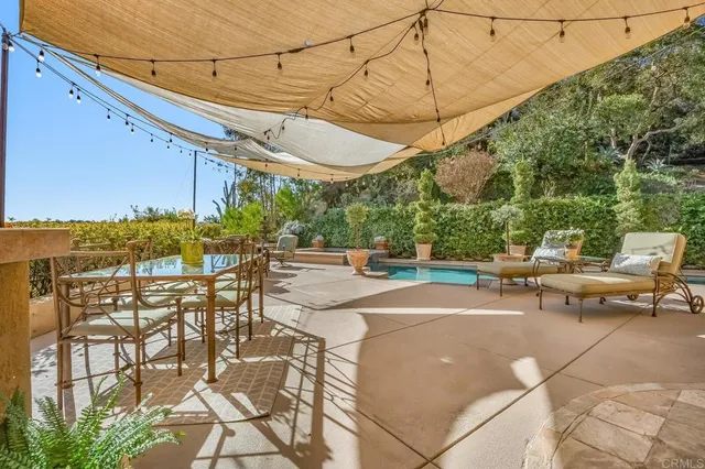 a view of a backyard with sitting area