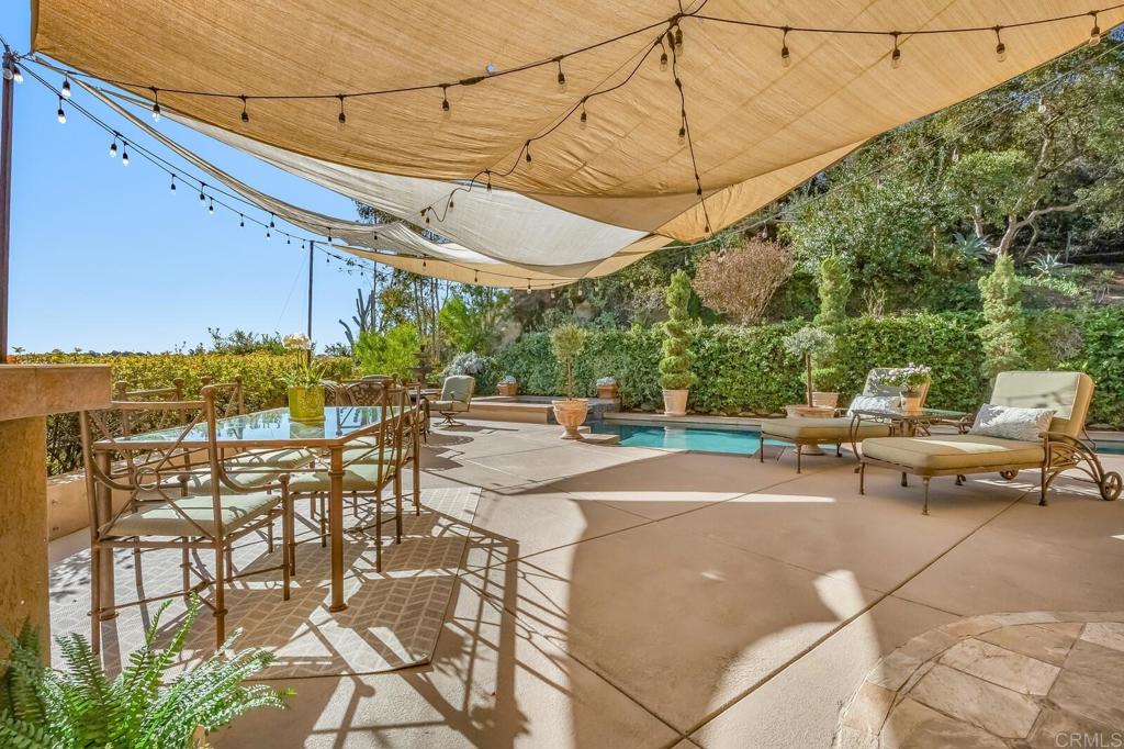 136 Hummingbird Hill Encinitas, CA 92024 - Photo 42 of 54 a view of a patio with a table and chairs