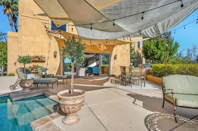 a view of a patio with couches and potted plants