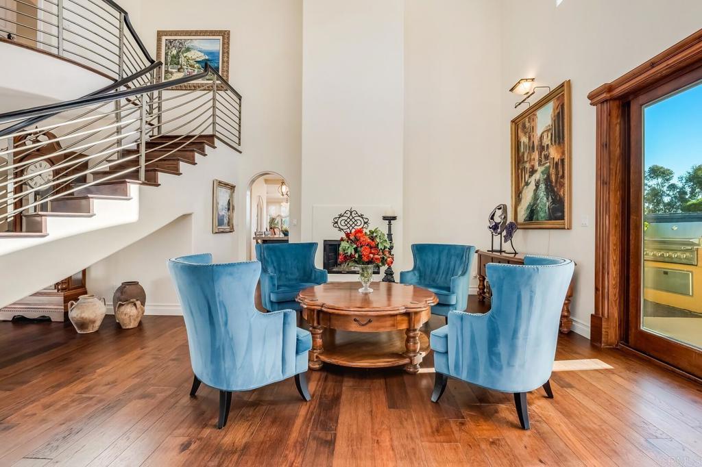 136 Hummingbird Hill Encinitas, CA 92024 - Photo 8 of 54 a dining room with furniture wooden floor a painting and a chandelier