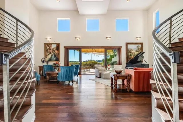 a living room with fireplace furniture and a wooden floor