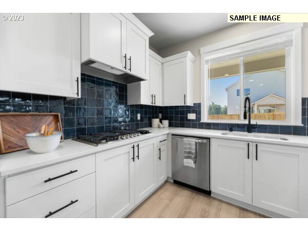 231 South 87th Avenue Ridgefield, WA 98642 - Photo 9 of 33 a kitchen with stainless steel appliances granite countertop a sink and cabinets