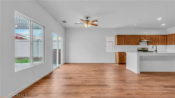 a view of kitchen with stainless steel appliances granite countertop a refrigerator and a sink