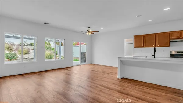 a view of a kitchen with a sink a fireplace and a window