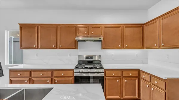 a kitchen with stainless steel appliances granite countertop a stove and cabinets