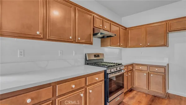 a kitchen with granite countertop cabinets stainless steel appliances and a sink
