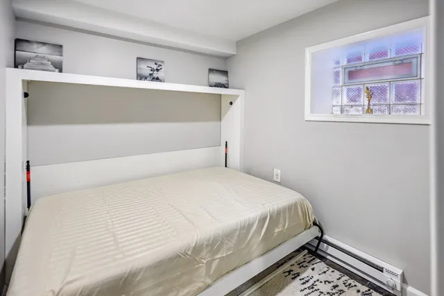 a bedroom with a bed and a window