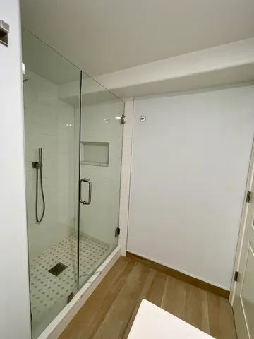 a bathroom with a glass shower door