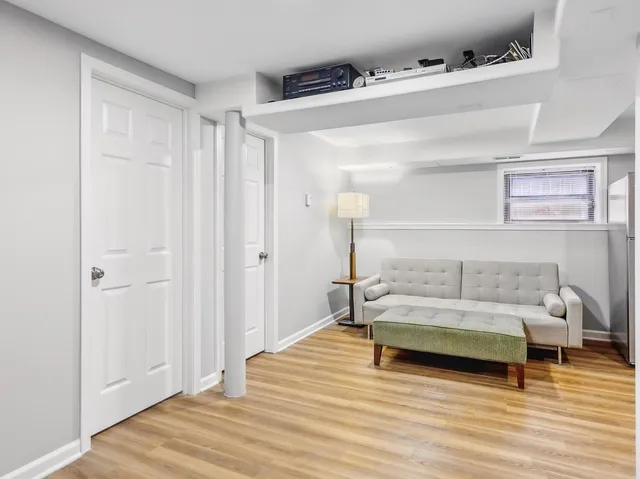 a bedroom with a bed and a wooden floor