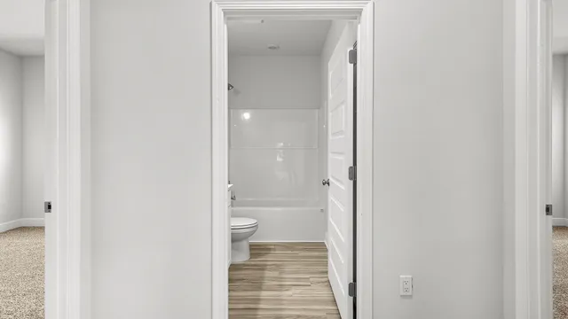 a bathroom with a granite countertop toilet and a shower