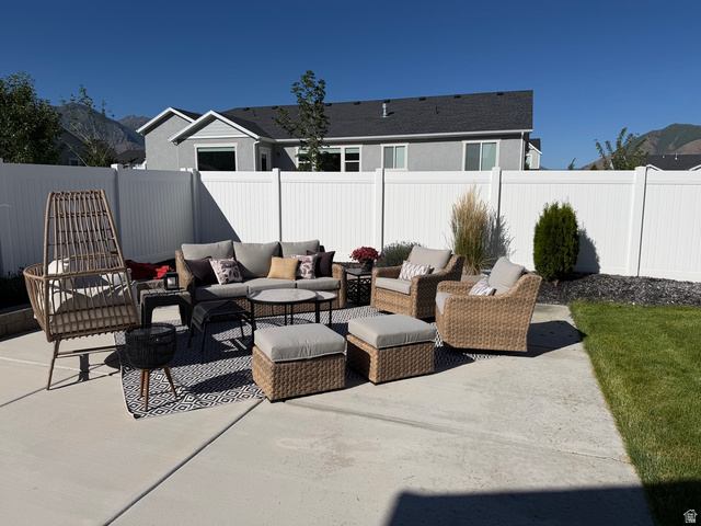 315 South Sherman Street Mapleton, UT 84664 - Photo 25 of 30 Concrete patio featuring a white privacy fence and a manicured lawn