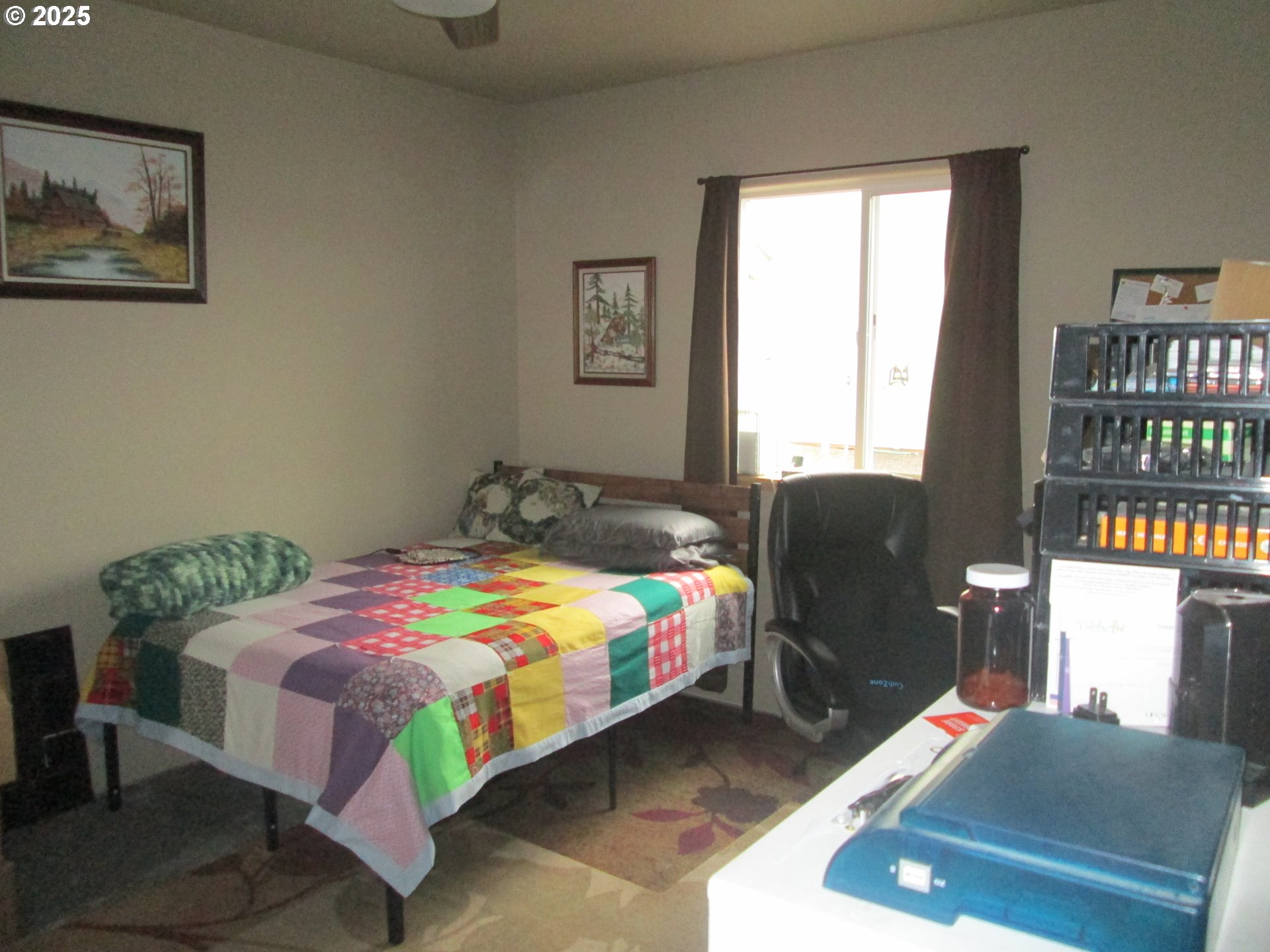 404 Pendleton Avenue Ukiah, OR 97880 - Photo 12 of 12 a bedroom with a bed bookshelf and a window